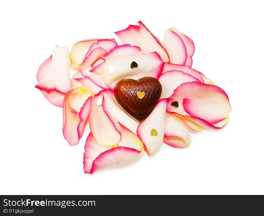 Soft focus of heart chocolate on rose petals