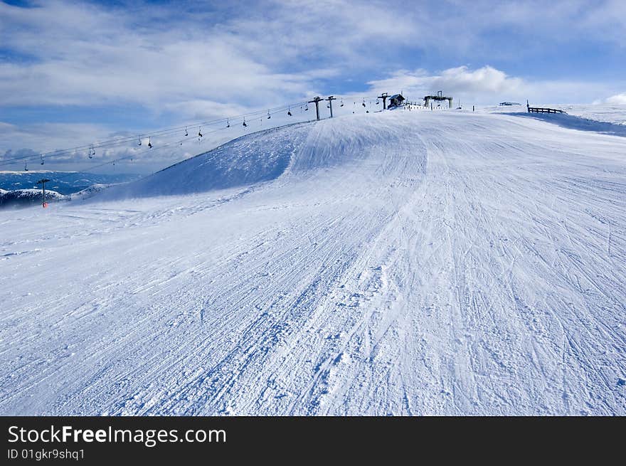 Snow covered mountain with ski lift in the background