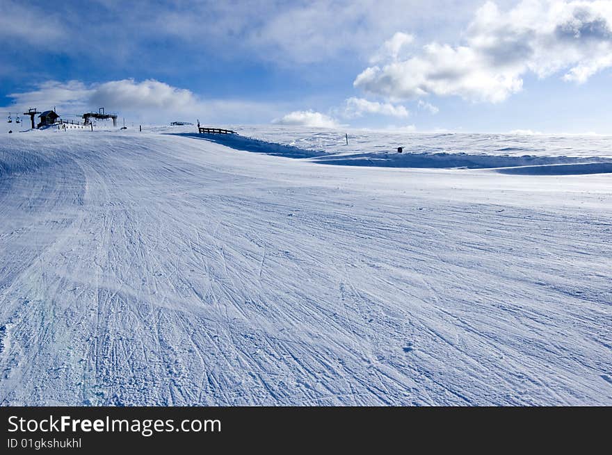 Snow covered mountain with ski lift in the background