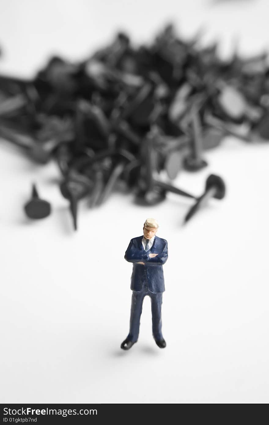 Businessman figurine placed with tacks. Businessman figurine placed with tacks