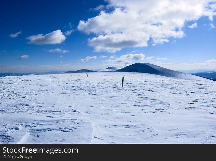 Snow covered mountain with cloudy and blue sky. Snow covered mountain with cloudy and blue sky