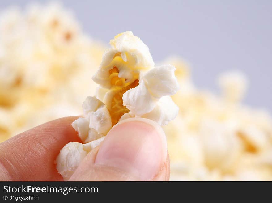 Closeup of a hand holding a popcorn