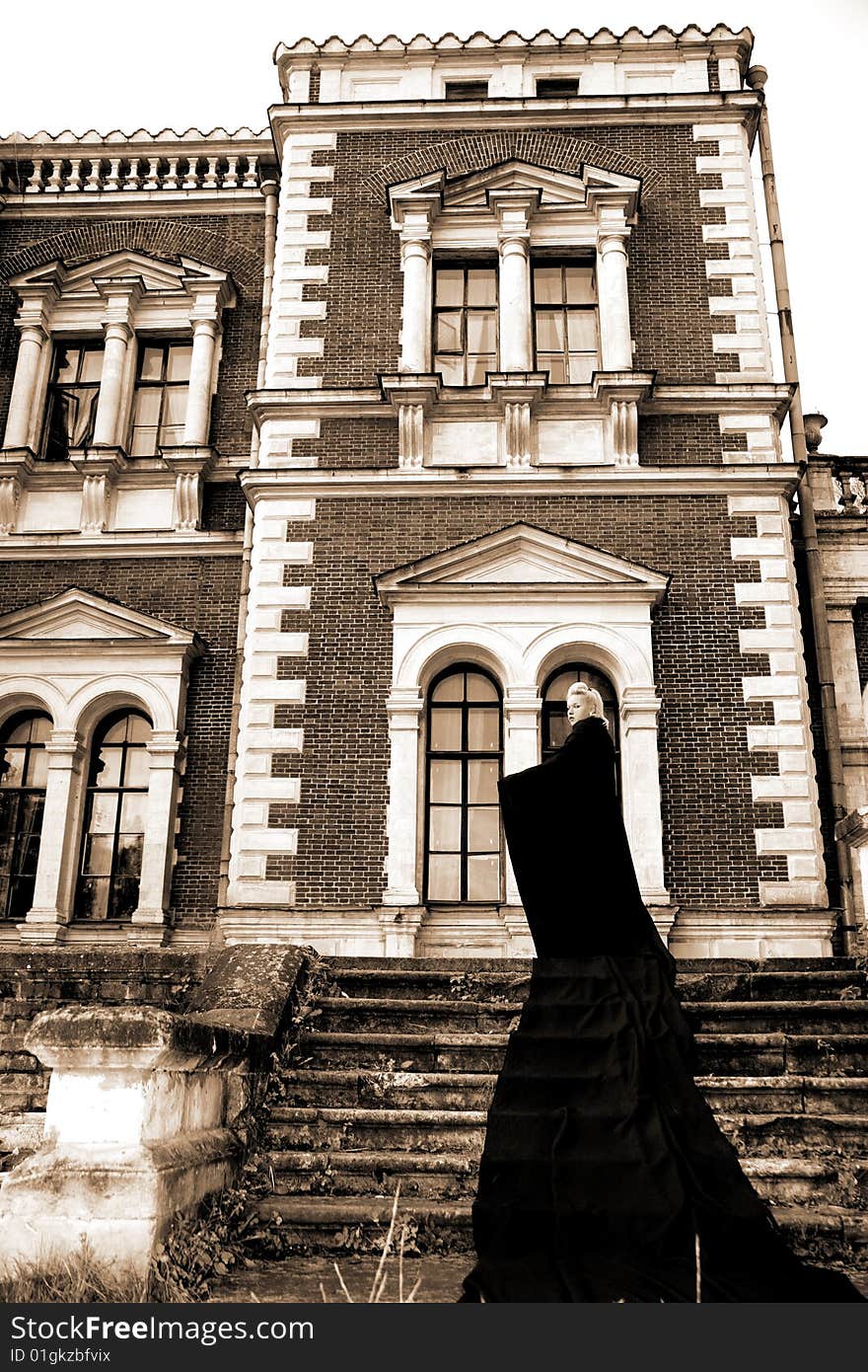 Lovely woman beside old house in black fabric. Lovely woman beside old house in black fabric