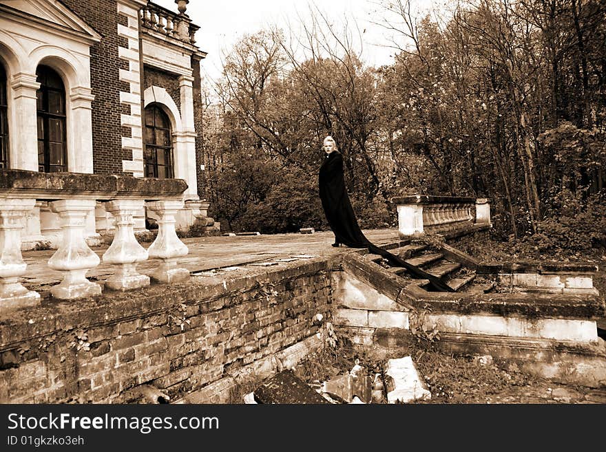 Lovely woman beside old house in black fabric. Lovely woman beside old house in black fabric