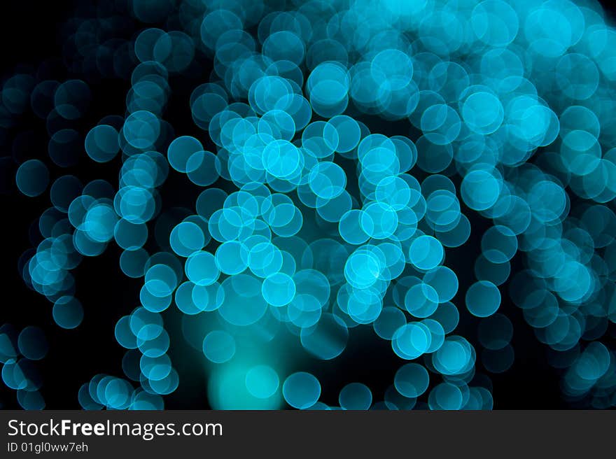 Blue colored fiber glass bokeh on a black background. Blue colored fiber glass bokeh on a black background