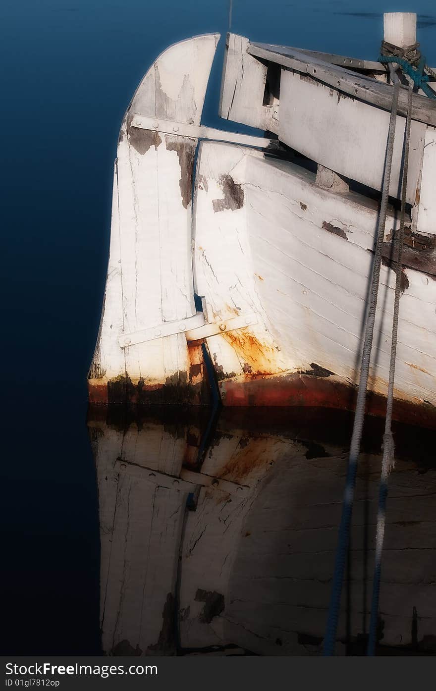 Old wooden boat, refurbishment object, blue stationary sea