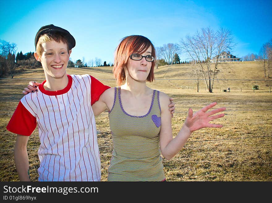 Two girls enjoying a peaceful afternoon in a field. Two girls enjoying a peaceful afternoon in a field