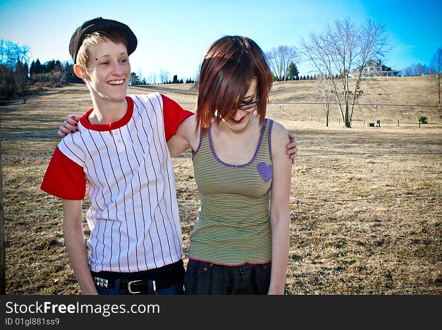 Two girls enjoying a peaceful afternoon in a field. Two girls enjoying a peaceful afternoon in a field