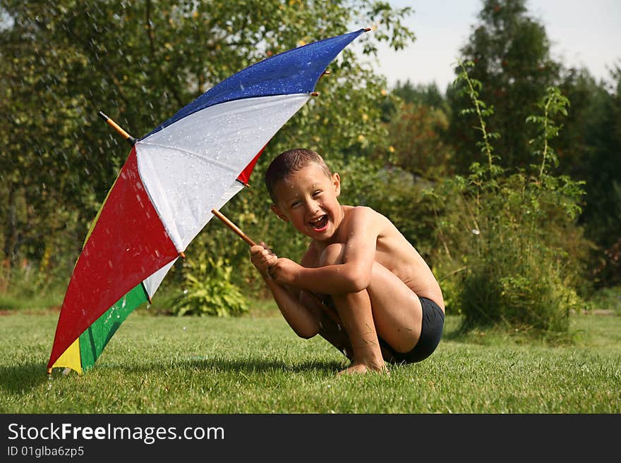 Little boy under umbrella in summer rine. Little boy under umbrella in summer rine