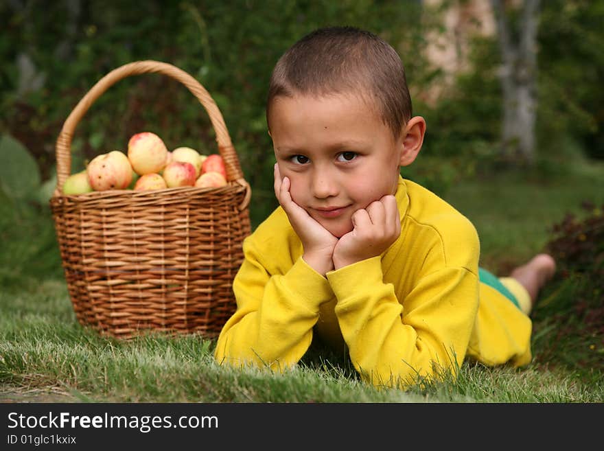 Little boy posing outdoors with apples. Little boy posing outdoors with apples