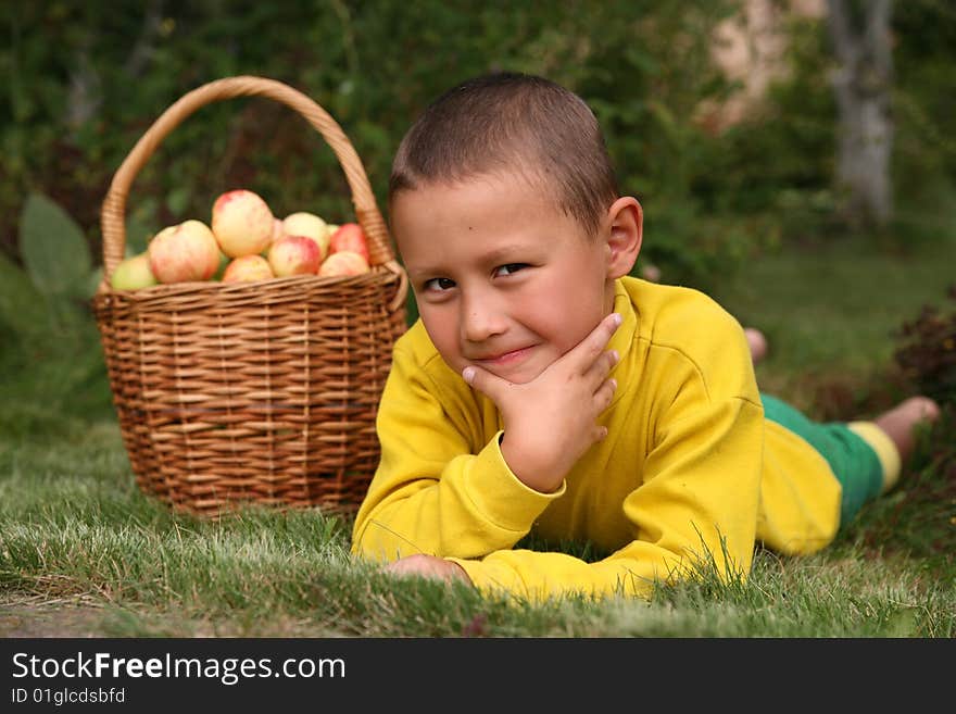 Little boy posing outdoors with apples. Little boy posing outdoors with apples