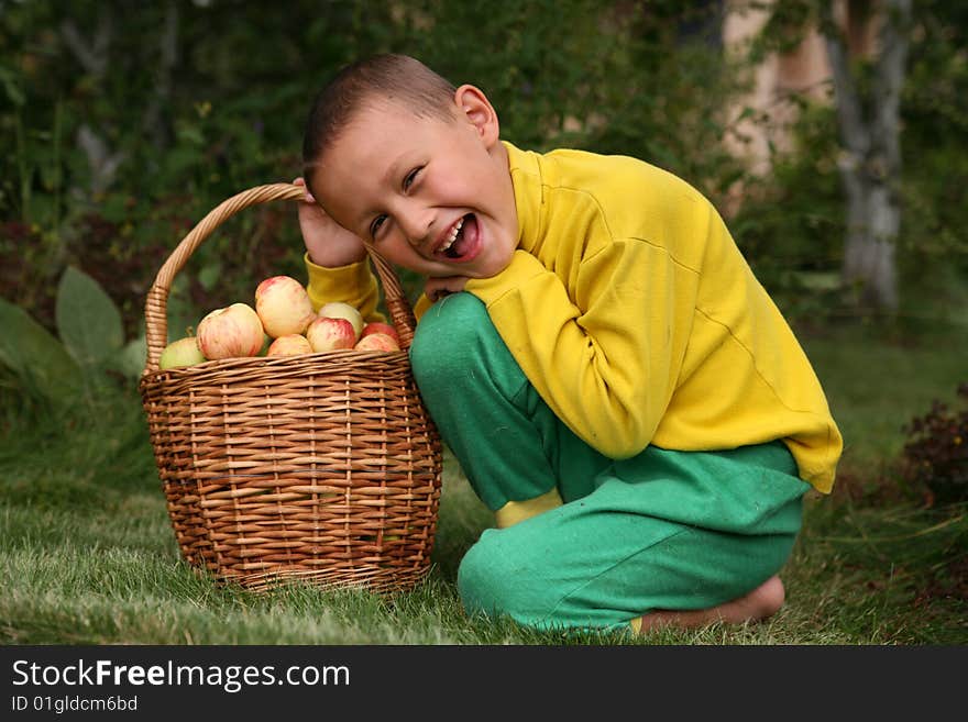 Little boy posing outdoors with apples. Little boy posing outdoors with apples