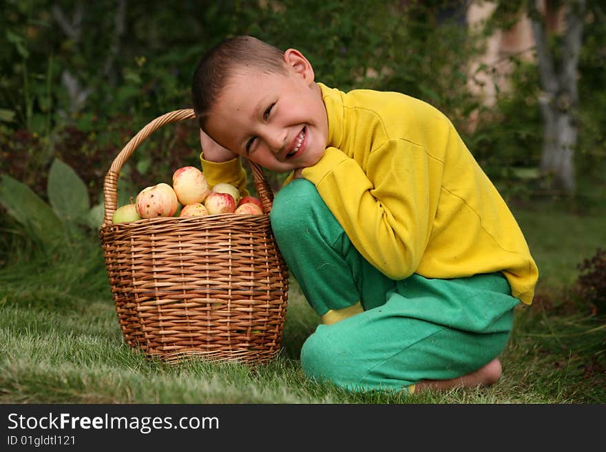 Little boy posing outdoors with apples. Little boy posing outdoors with apples