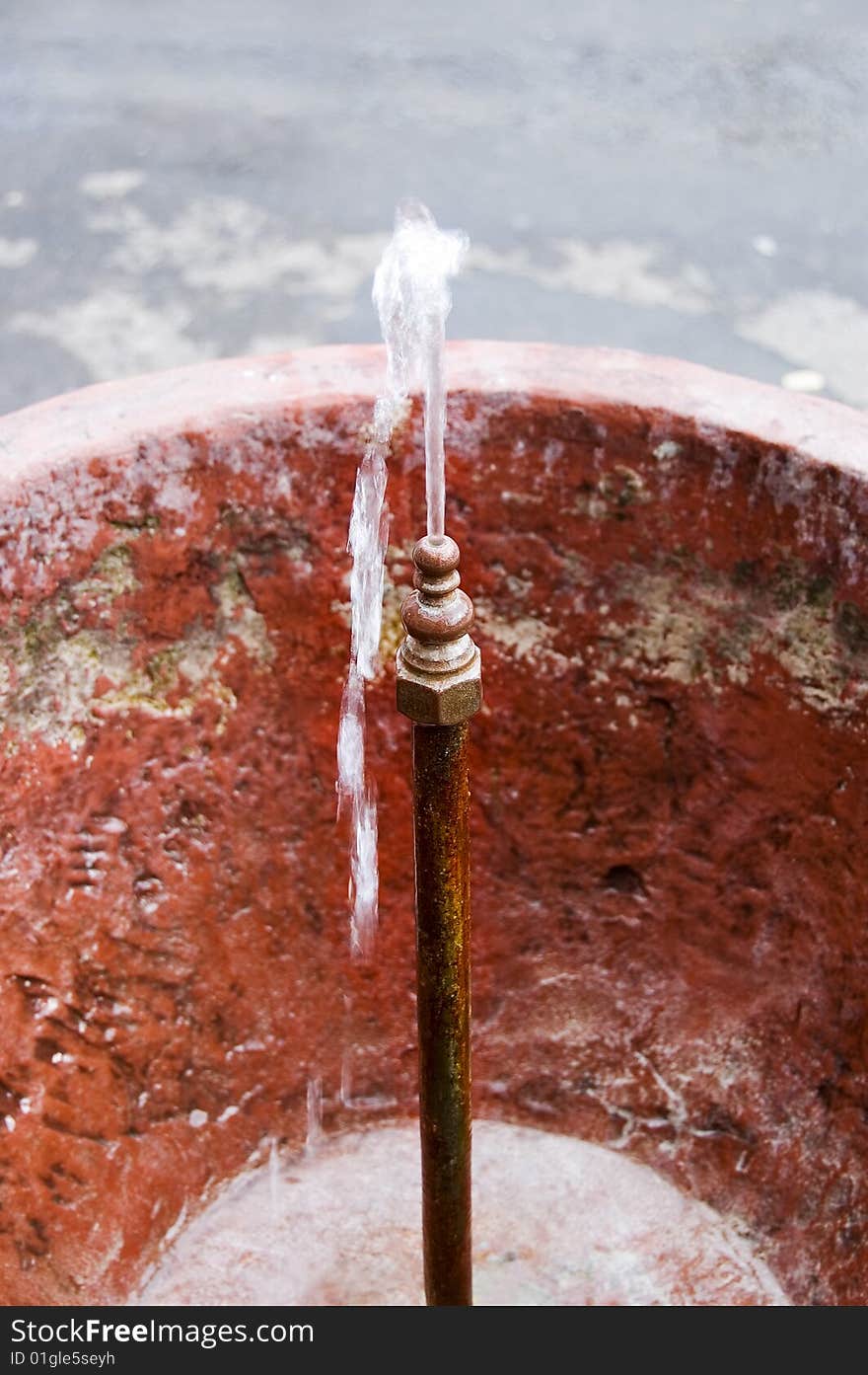 Splashing water from the little red fountain