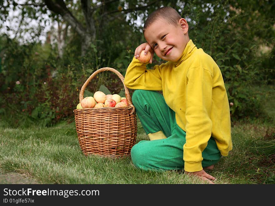 Little boy posing outdoors with apples. Little boy posing outdoors with apples