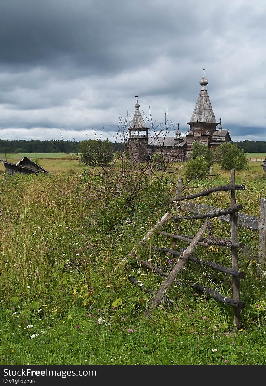 Ancient wooden russian church, storm-clouds in sky