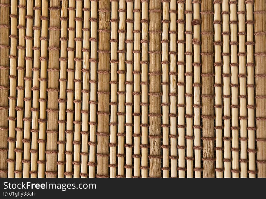 Woven background. Mat made out of bamboo pieces. Woven background. Mat made out of bamboo pieces