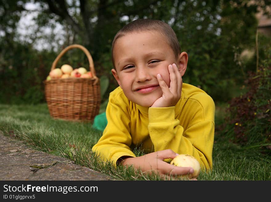 Little boy posing outdoors with apples. Little boy posing outdoors with apples