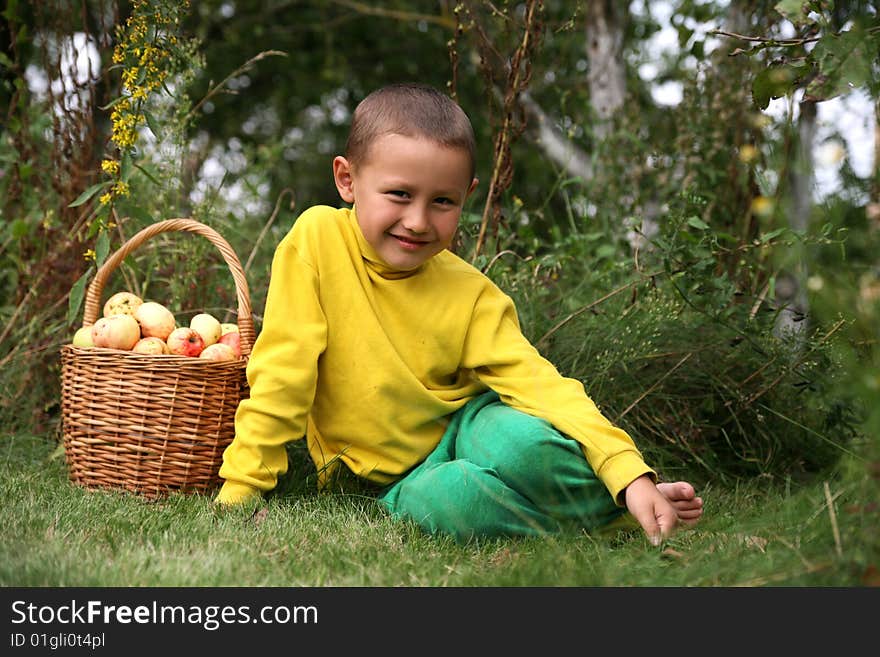 Little boy posing outdoors with apples. Little boy posing outdoors with apples