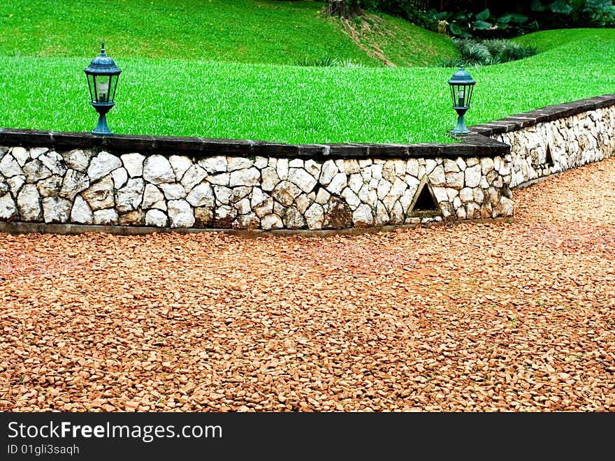 Beautiful scene of a footpath with a lawn on the background. Beautiful scene of a footpath with a lawn on the background