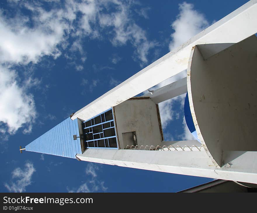 Low angle shot of a blue and white church pointing towards the sky. Low angle shot of a blue and white church pointing towards the sky.