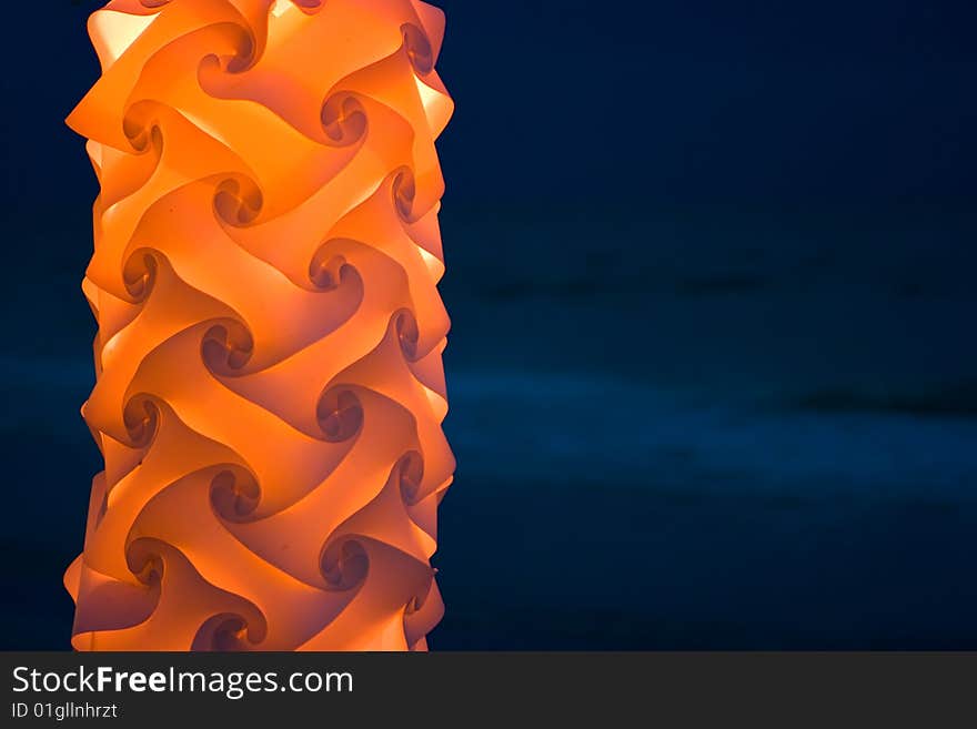 Orange lantern giving light on night beach. Orange lantern giving light on night beach