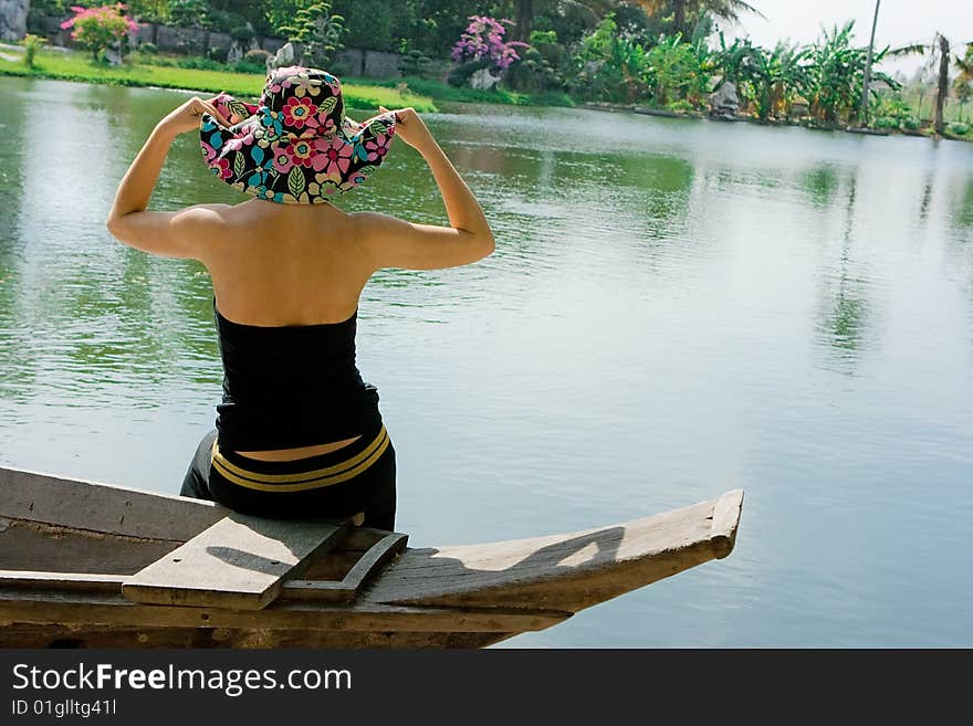 Girl in flower hat on the boat. Girl in flower hat on the boat