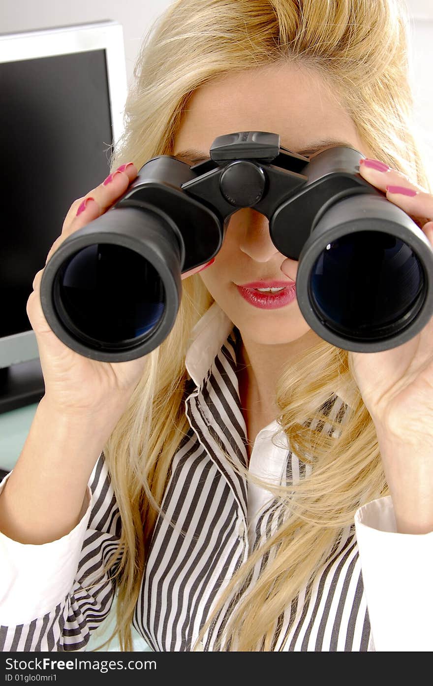 Front view of female looking through binocular in an office