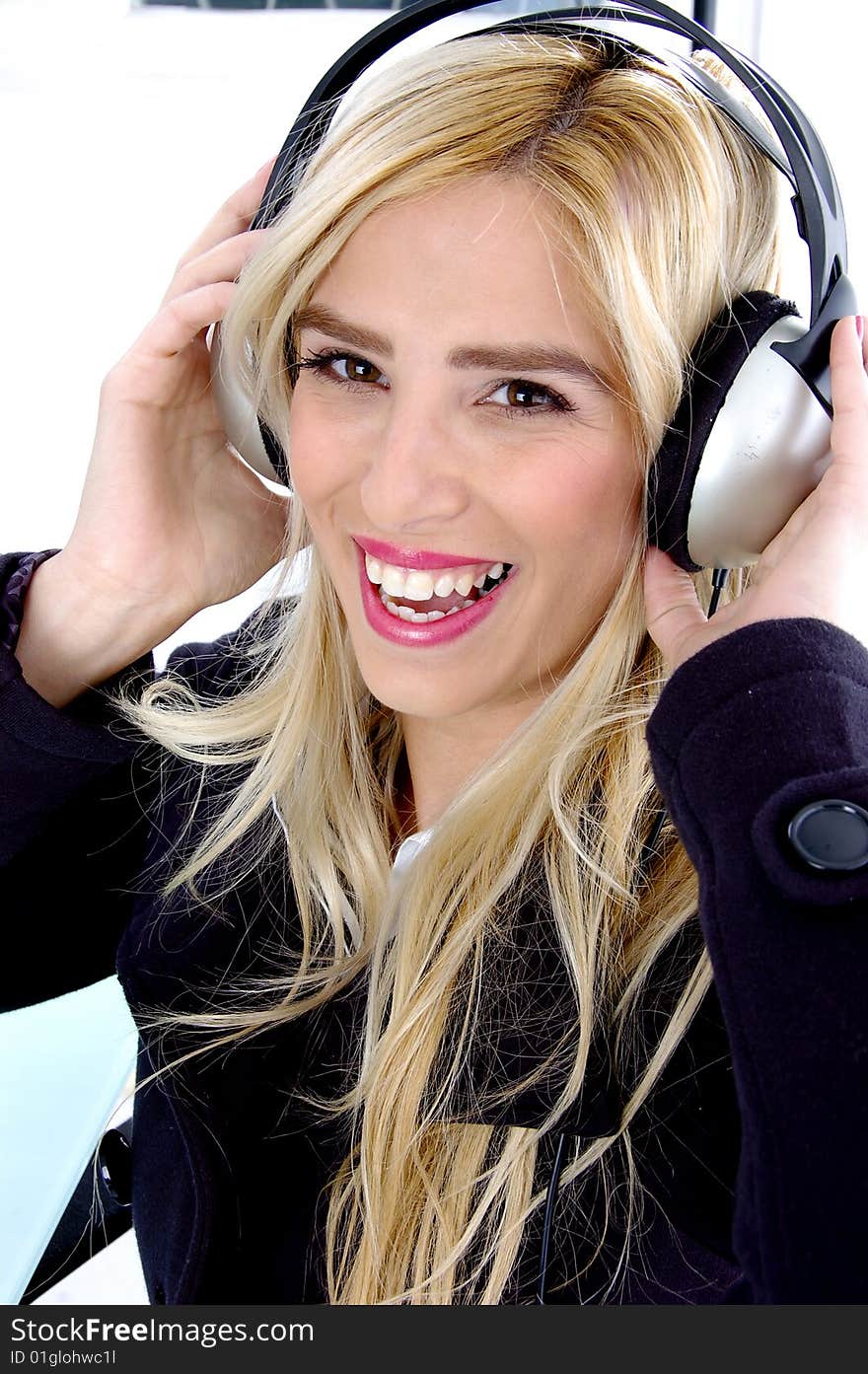 Side view of smiling woman listening music