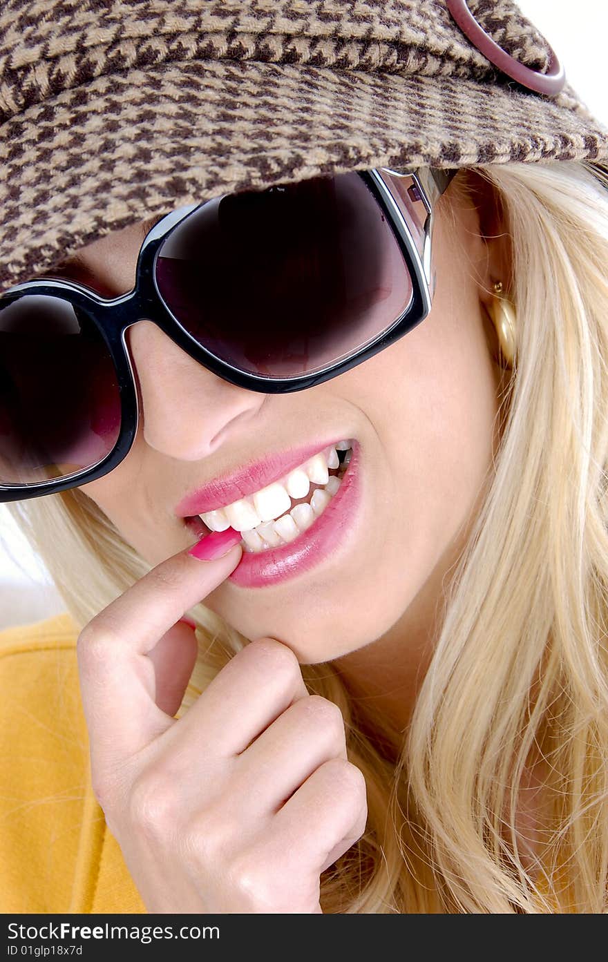 Front view of smiling female biting her finger