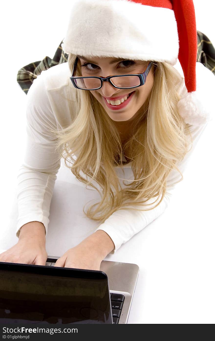 Woman in christmas hat working on laptop