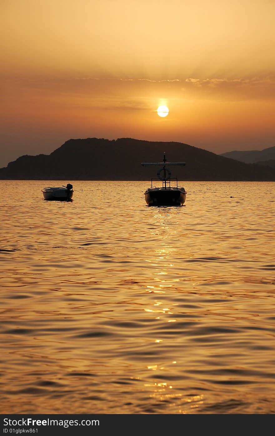 Two boats at sunset. Montenegro. Two boats at sunset. Montenegro