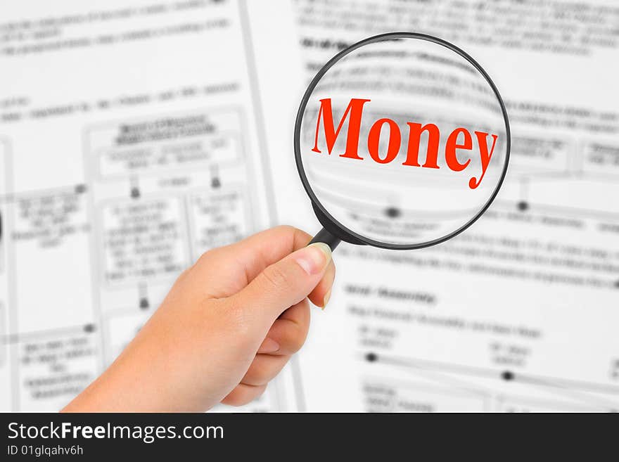 Magnifying glass in hand and word Money, business background