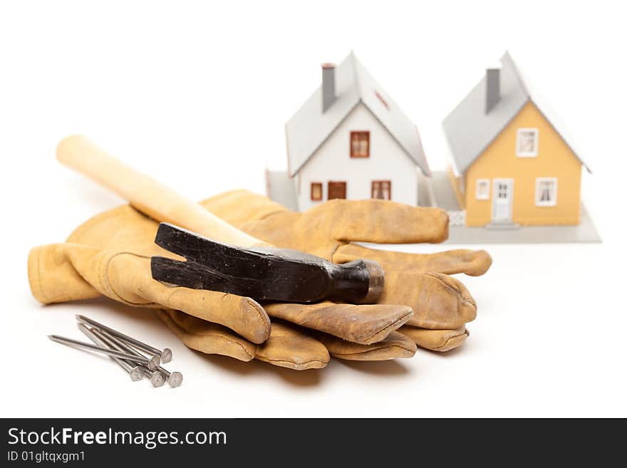 Hammer, Gloves, Nails and House Isolated on a White Background.