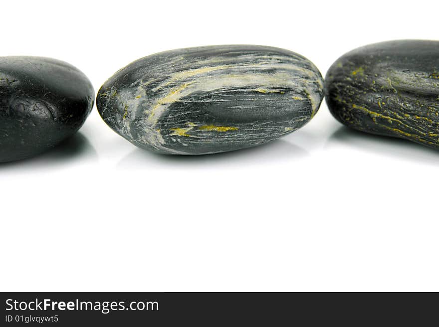 Black river rocks isolated against a white background