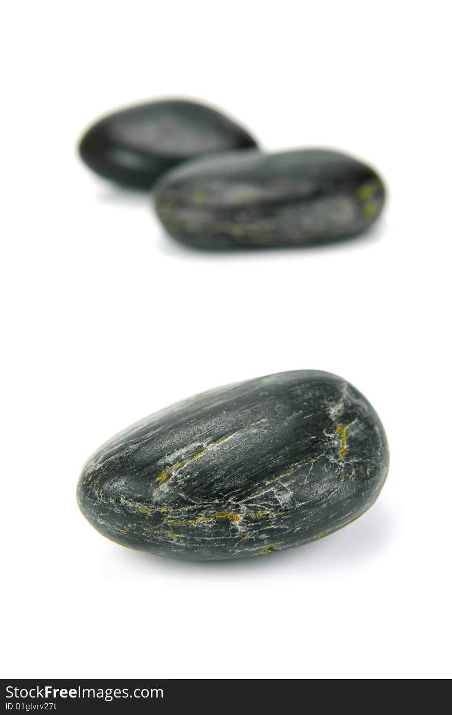 Black river rocks isolated against a white background