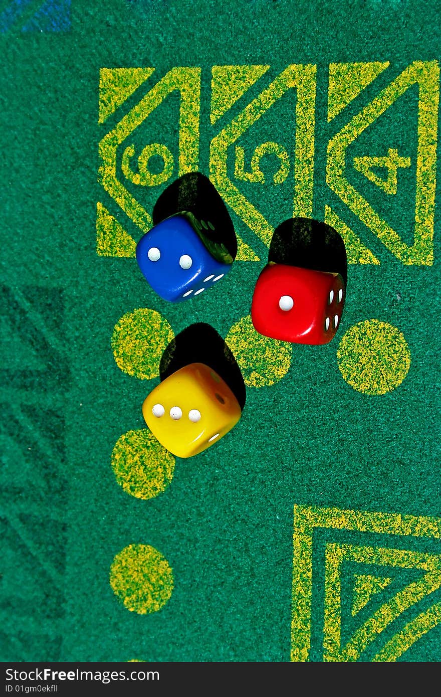 Three dice with number one, two, three in green table game