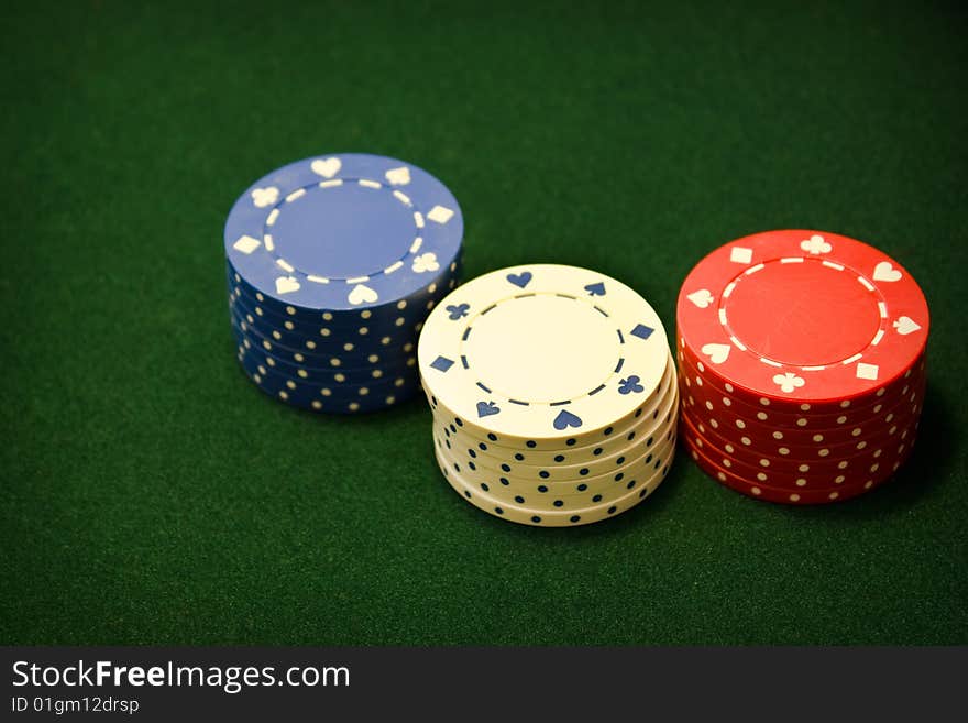 Set of poker chips on green felt. Set of poker chips on green felt.