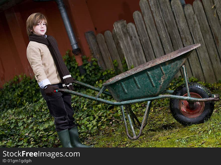 Cute boy and wheelbarrow