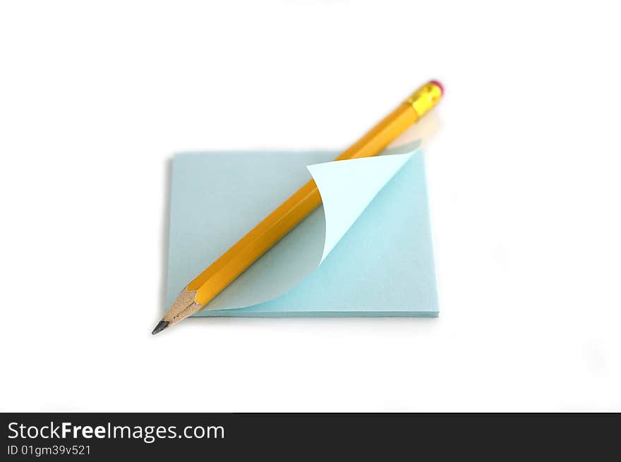 Pencil and note against the white background. Pencil and note against the white background