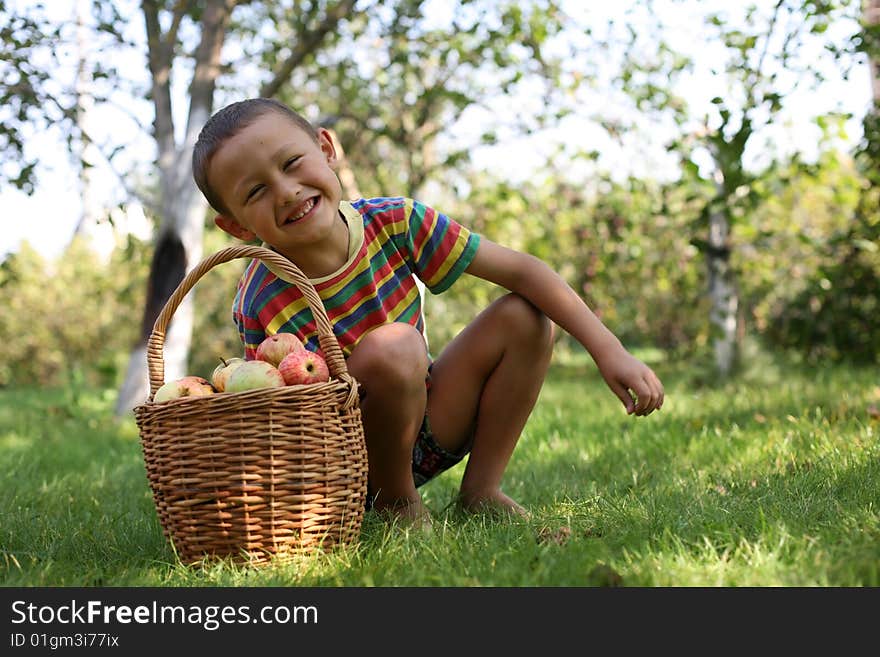 Little boy posing outdoors with apples. Little boy posing outdoors with apples