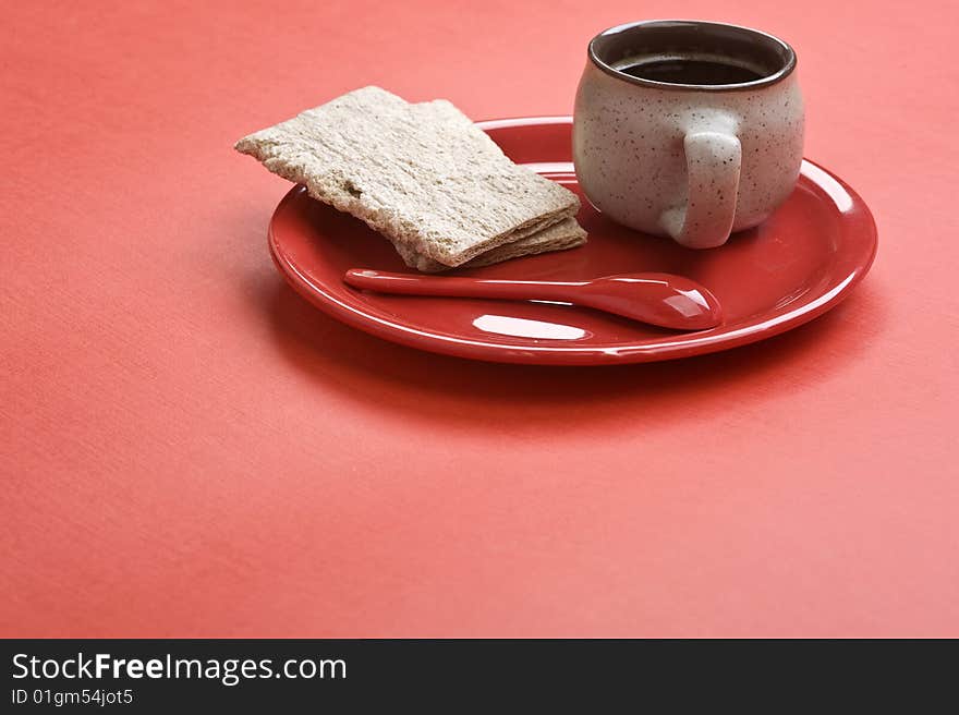 Breakfast. Coffee cup and toasts on red table.