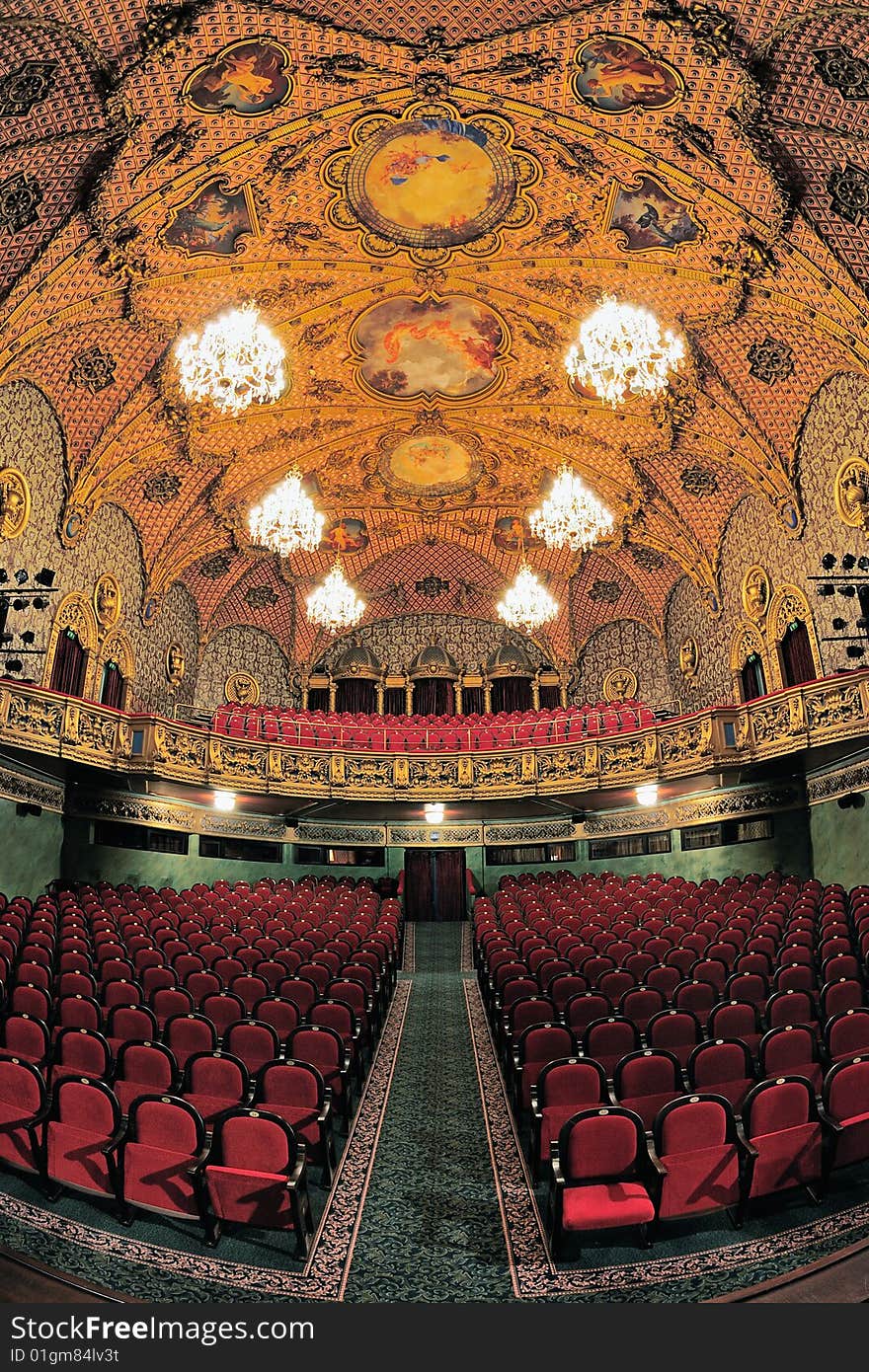 Empty auditorium with red chairs and a painted ceiling. Empty auditorium with red chairs and a painted ceiling