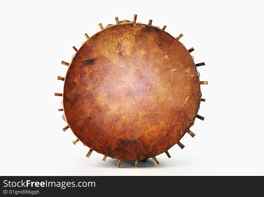 Ancient tambourine from a skin and wood on a white background