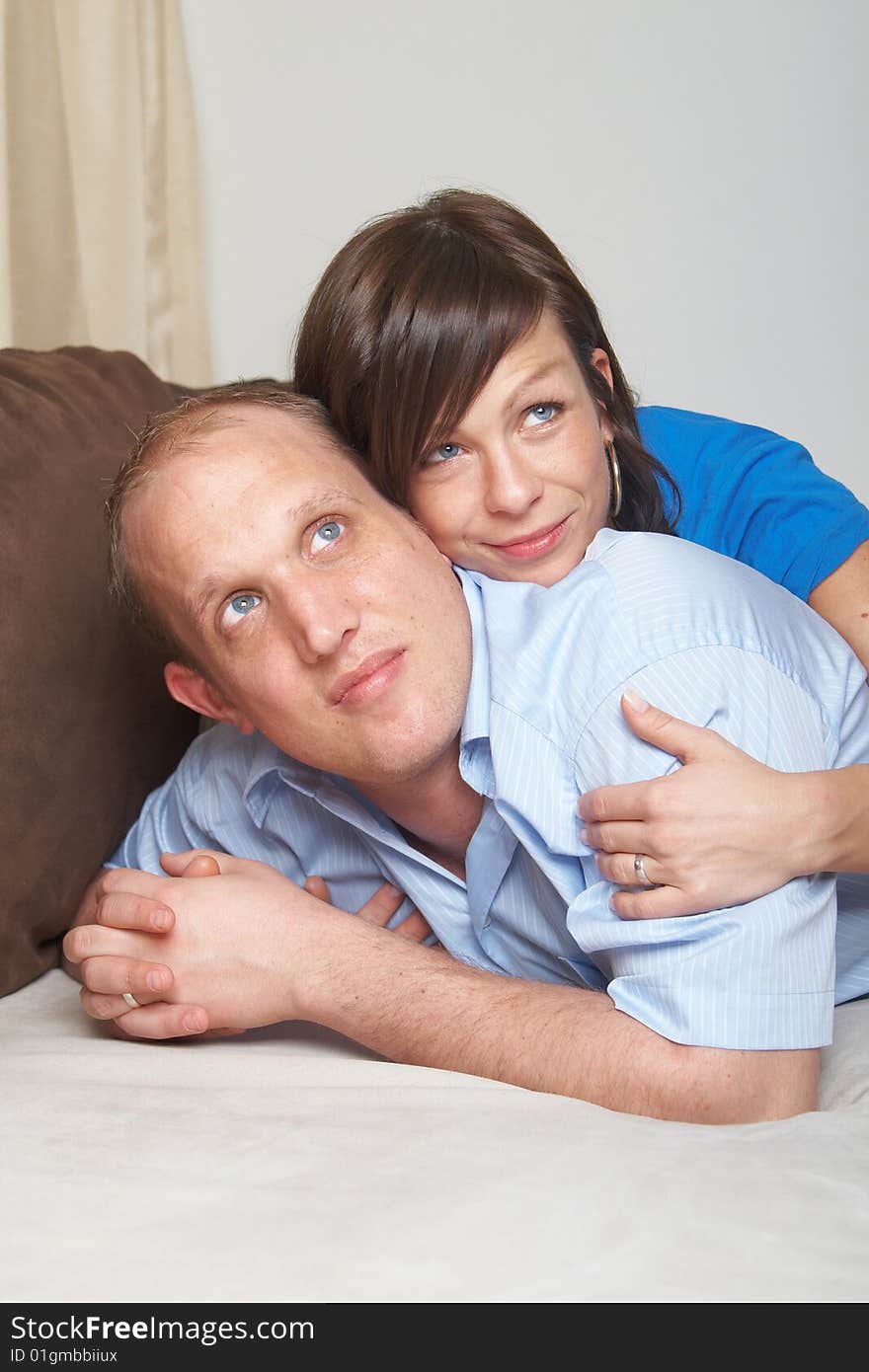 Beautiful young couple on a couch in their new appartment. Beautiful young couple on a couch in their new appartment.