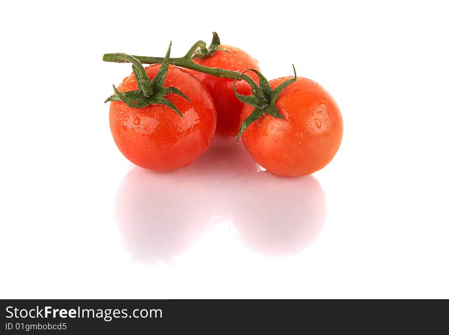 Macroshot of a bunch of tomatoes with drops of water. Isolated over white background. Lot of copyspace. Macroshot of a bunch of tomatoes with drops of water. Isolated over white background. Lot of copyspace.