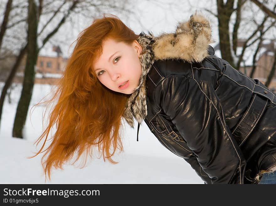 Portrait of the young beautiful woman with red hair