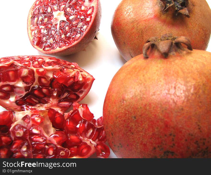 Full Pomegranates and Cut ones on white Background