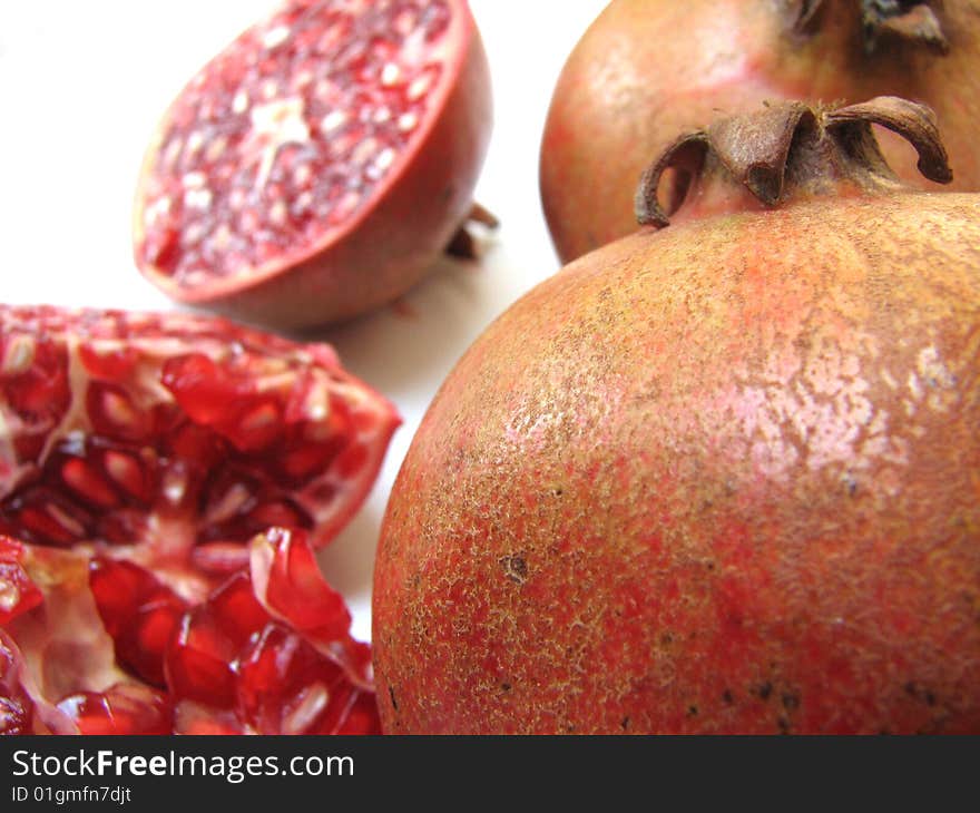 Close-up of Full Pomegranate skin and blur view of half Cut one on white Background. Close-up of Full Pomegranate skin and blur view of half Cut one on white Background