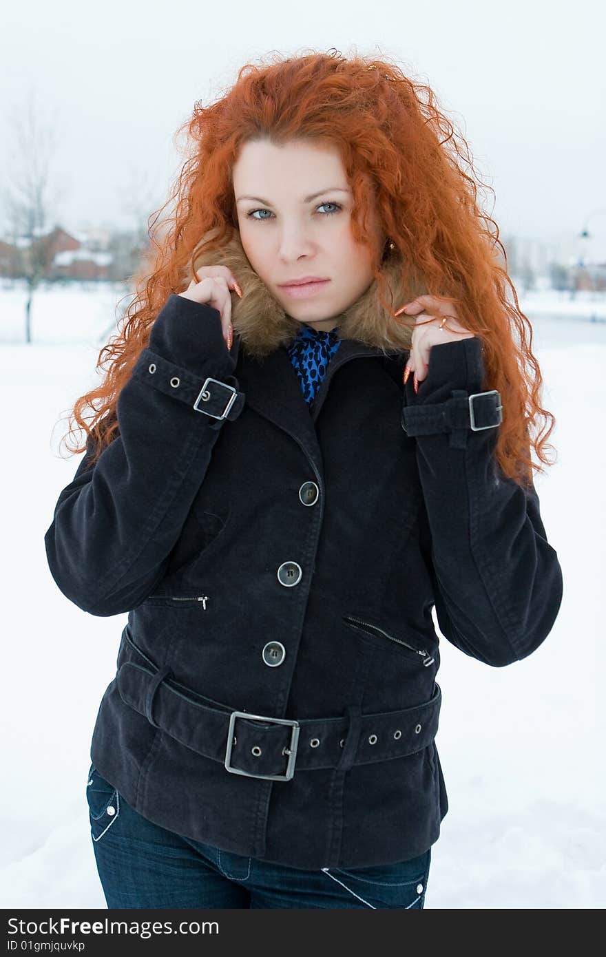 Portrait of the young beautiful woman with red hair